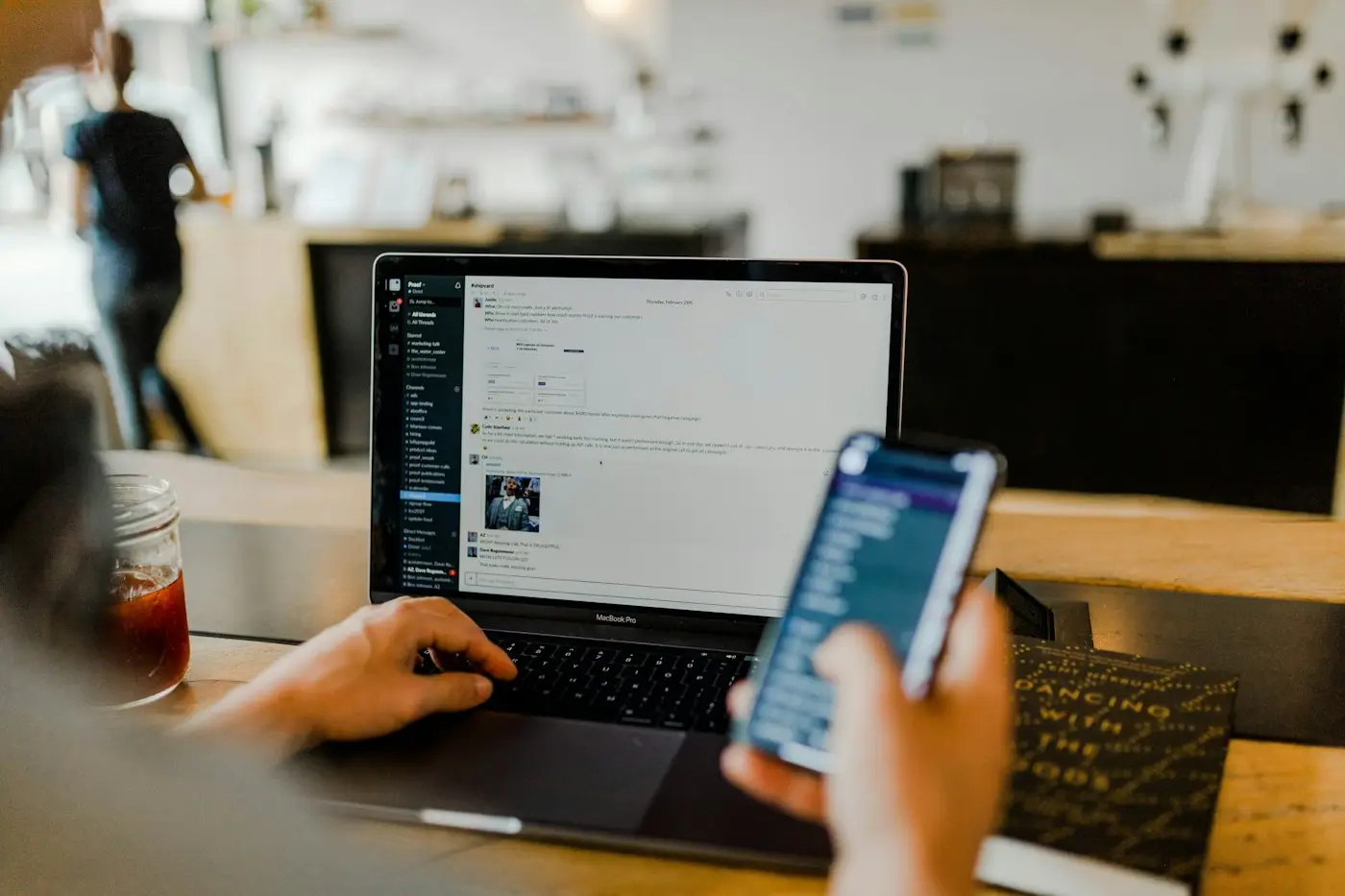 Person checking email on laptop and phone